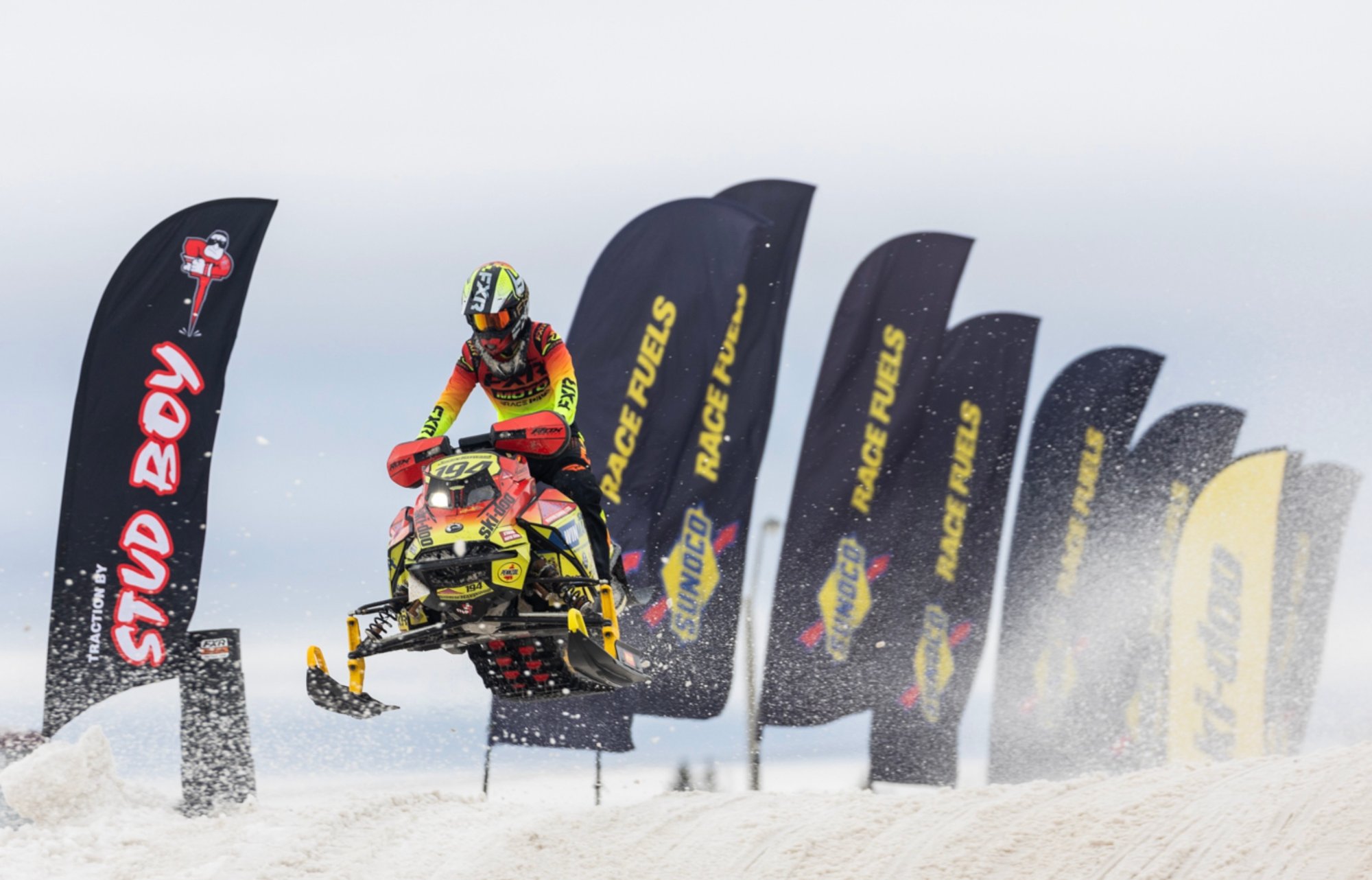 Snow Mobile Racer Going Over Jump